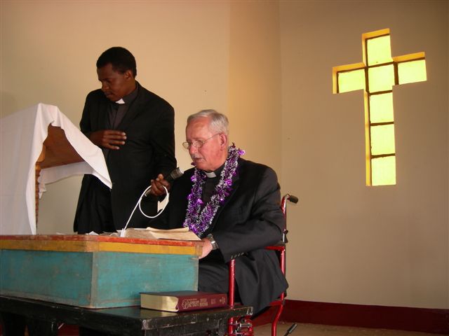 Hoyt Osborne preaching with Pastor Sammy translating, 2012. Perhaps at dedication.