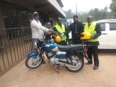 Pastor Timothy receiving motorcycle from Gideon and Makosi of Kisii Fellowship.