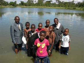 Baptism in a pond for Tala Church with Pastor Fitz and Deacon Peter