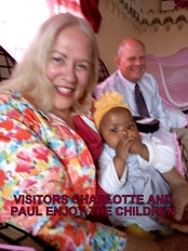 Visitors Charlotte and Paul enjoy the children.