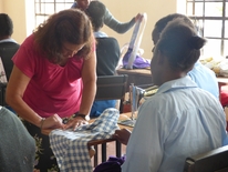 Cindy Donarico assisting with teaching sewing. July, 2017